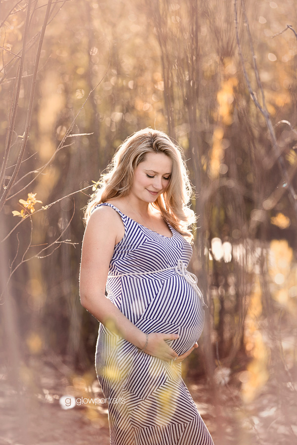 outside in trees maternity pose long dress