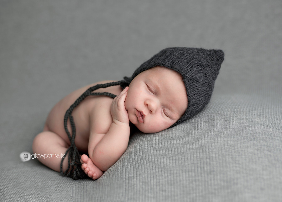 fort st john newborn photographer beanbag pose newborn with hand on face