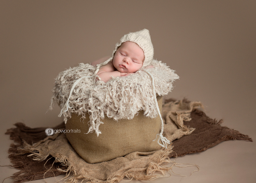 british columbia newborn photographer newborn in bucket with hat