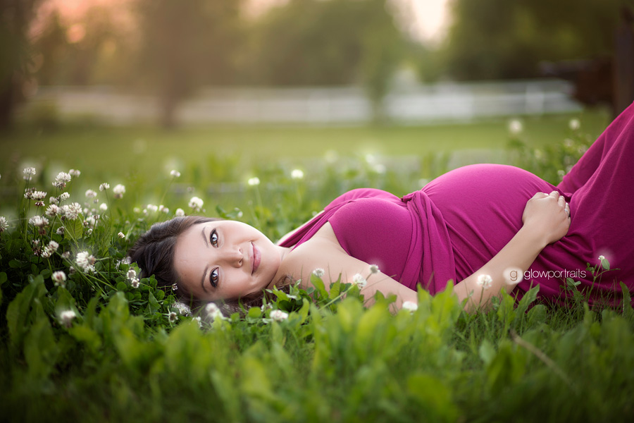 fort st john maternity photographer maternity lying down on grass field