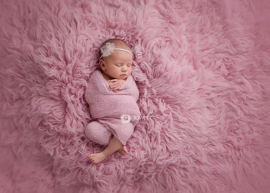 british columbia newborn photographer baby girl on pink fur wrapped