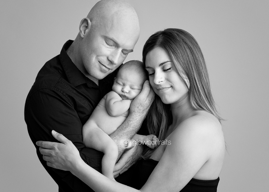 mom and dad holding newborn baby