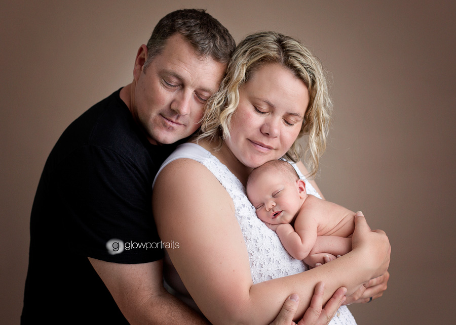 newborn photographer glow portraits mom and dad newborn pose