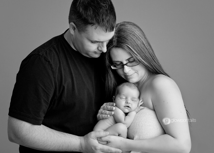 mom and dad and newborn pose