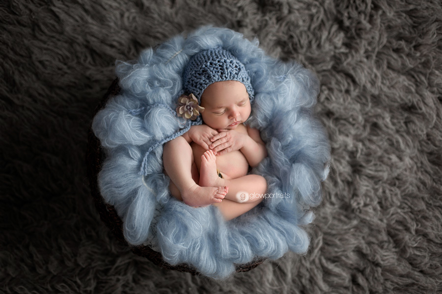 newborn on fur rug