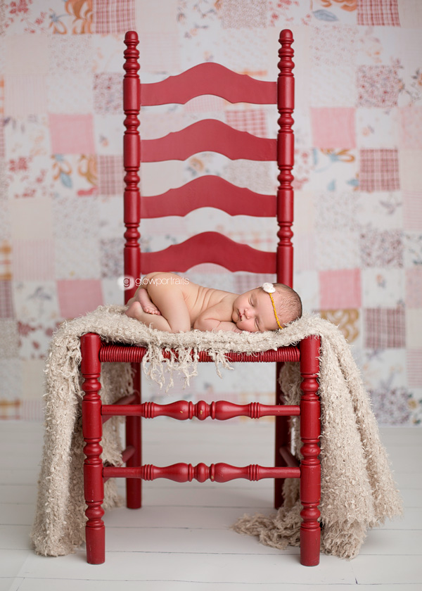 newborn on red chair