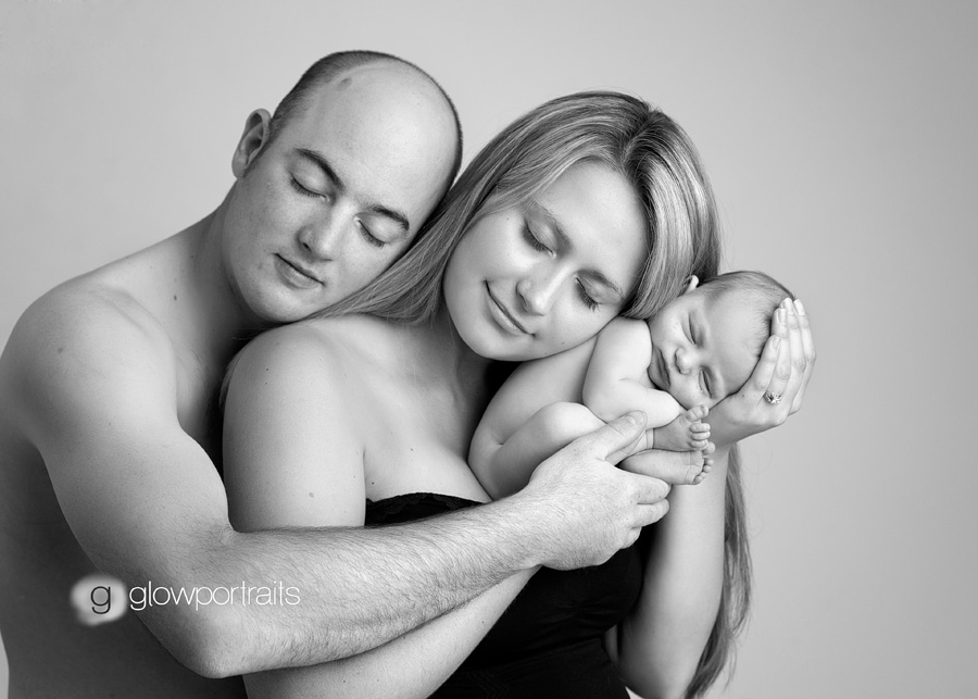 glow portraits mom dad newborn in snuggling pose