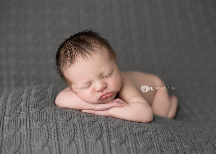 newborn resting on arms pose