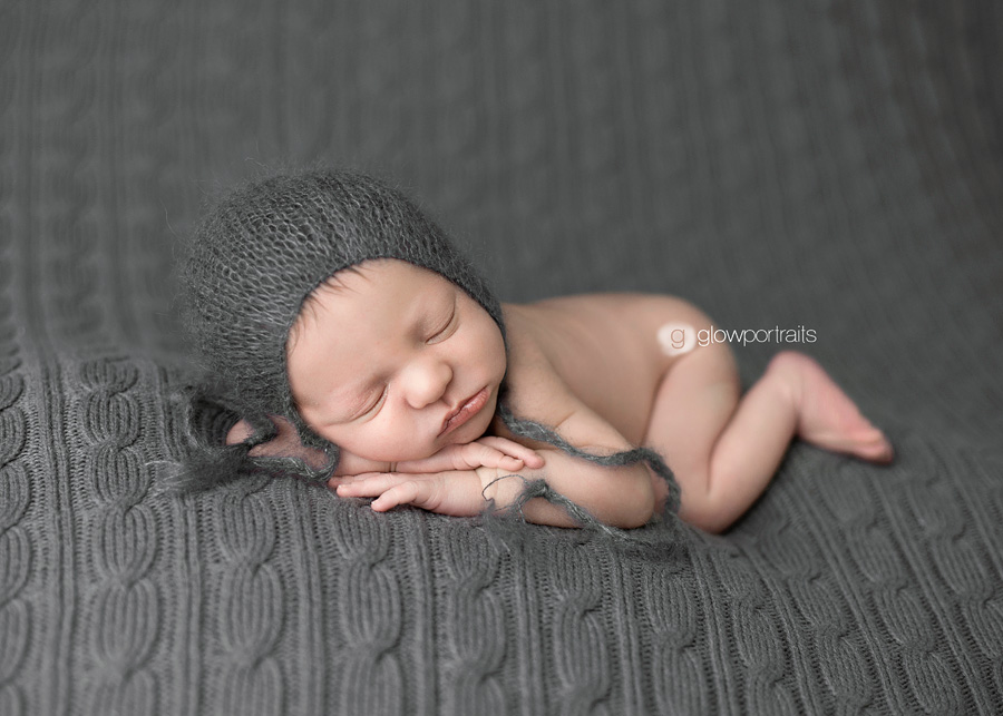 newborn on beanbag with hat on