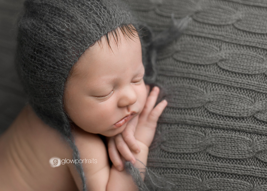 close up of newborn with hat on