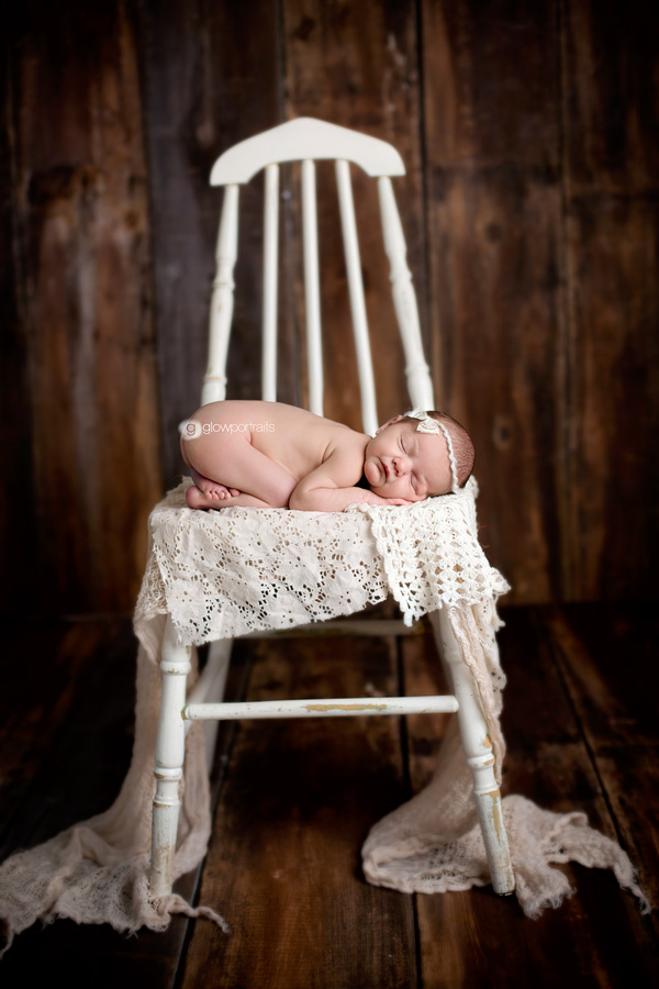 newborn girl on chair 