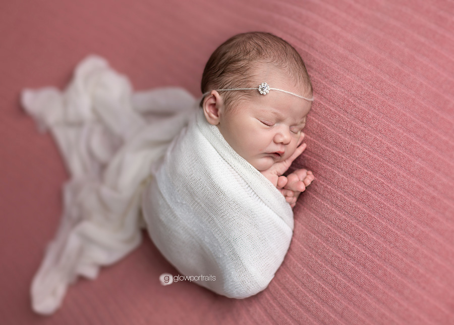 newborn baby on beanbag wrapped
