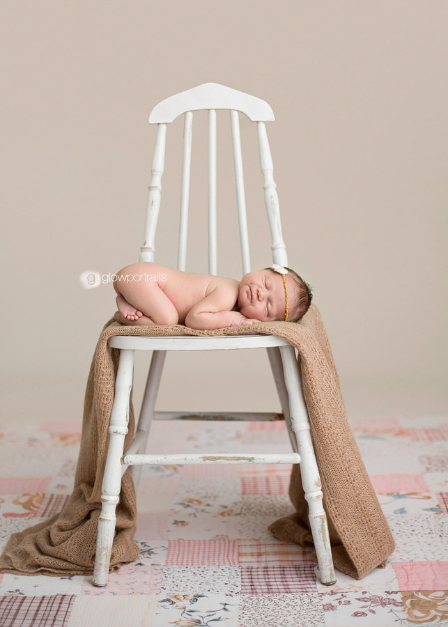 newborn posed on chair