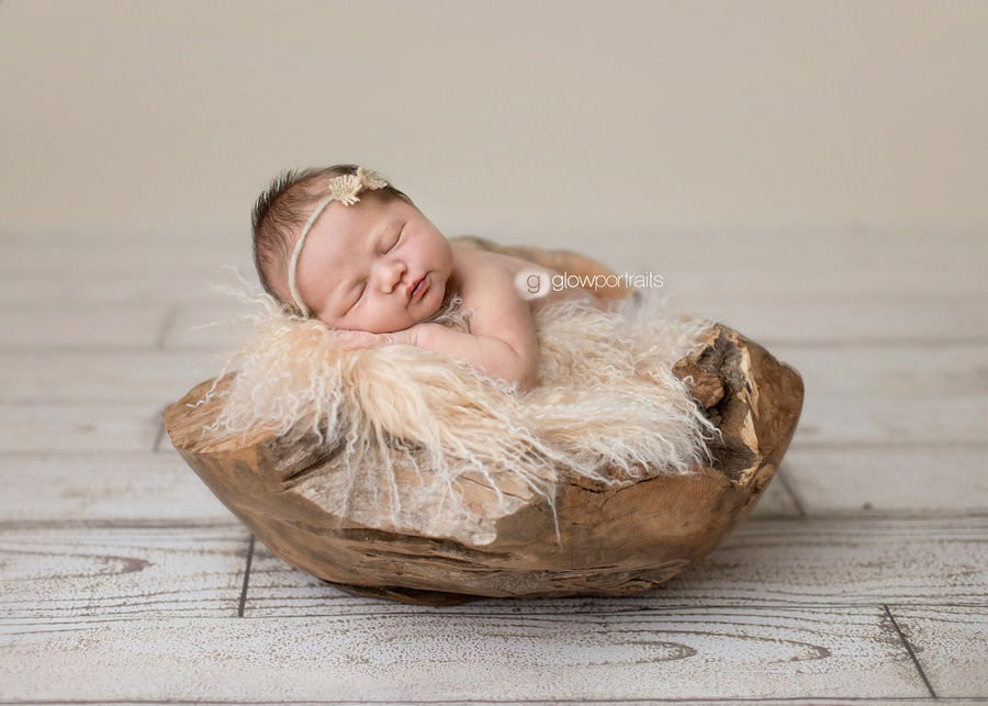 newborn baby in wooden bowl