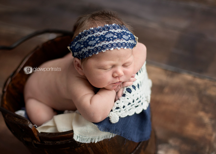 newborn girl in bucket from above