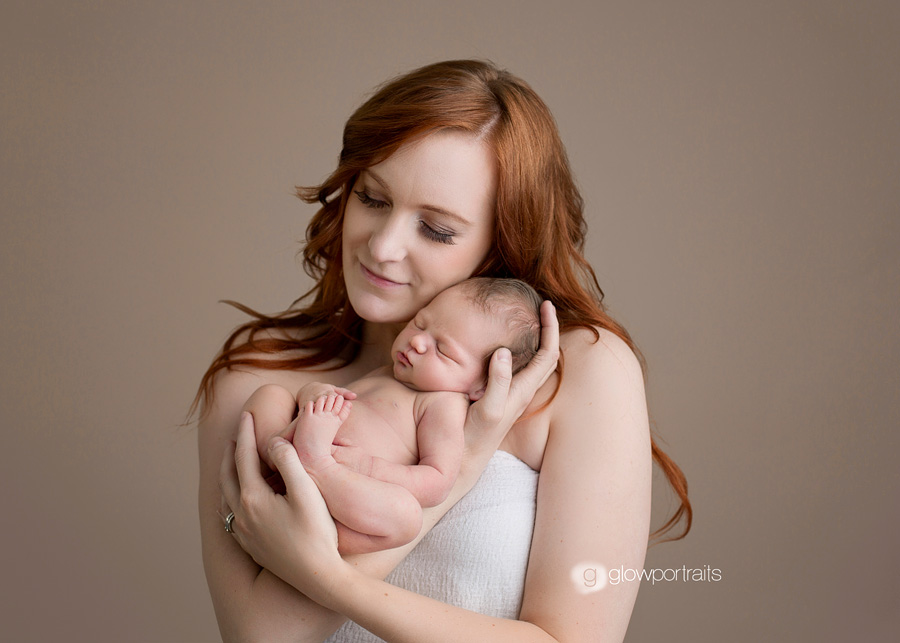 mom snuggling newborn