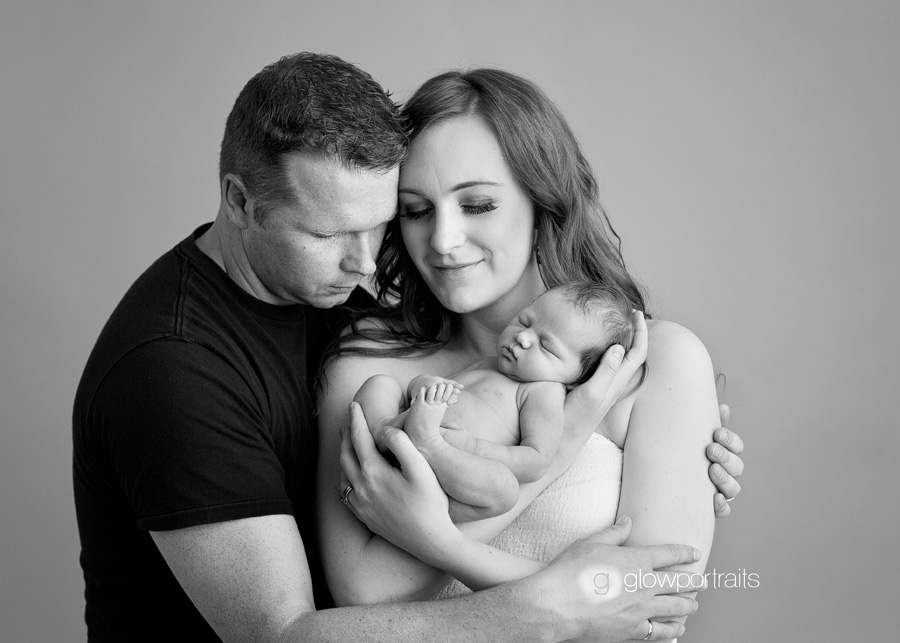 mom and dad holding newborn