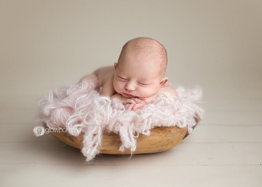 allison peck newborn baby girl in pink fluff in wooden bowl