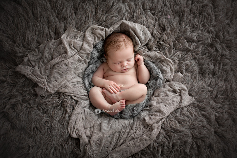 baby on gray fur rug