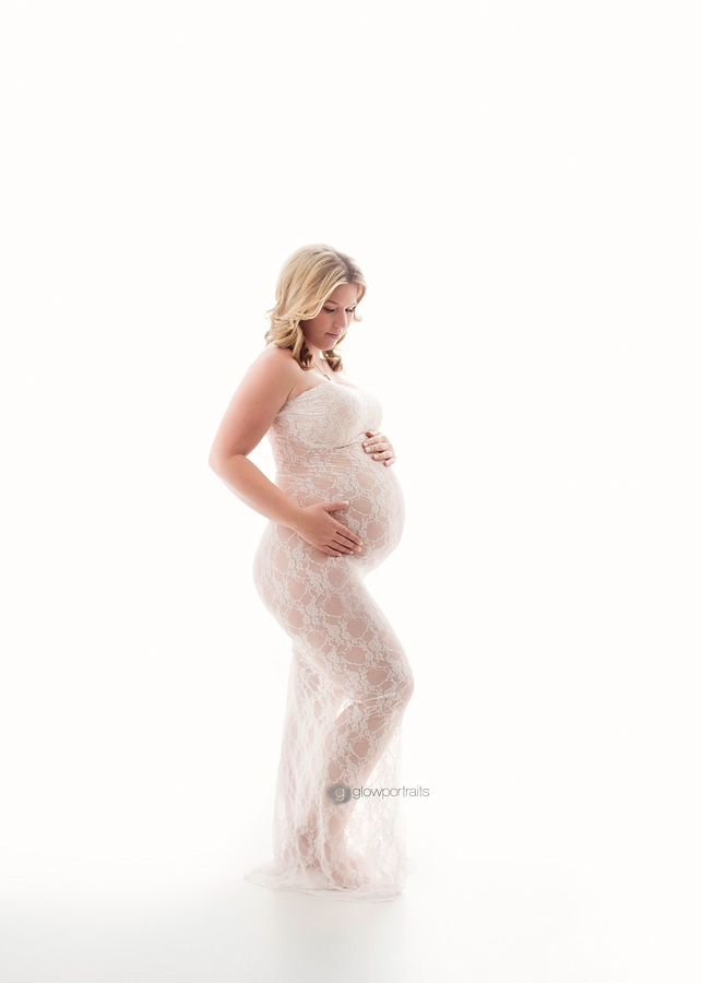 full length maternity pose wearing long lace gown
