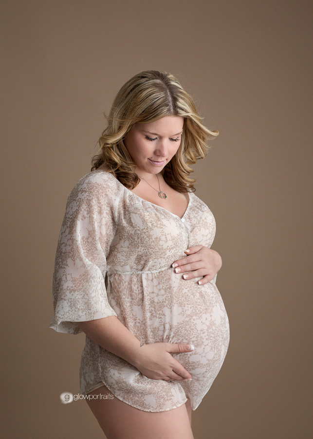side view of mom holding belly for maternity pose