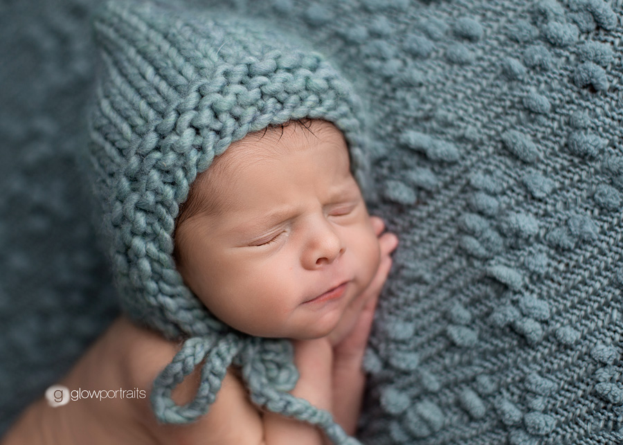 close up of newborn baby with hat on beanbag