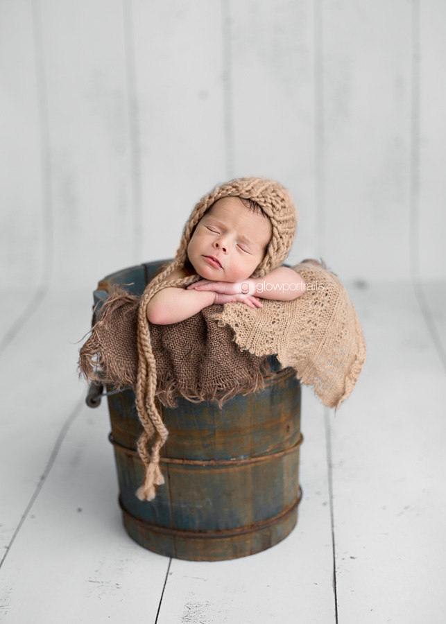 newborn boy in bucket