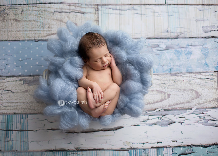 baby boy in blue fur on floor