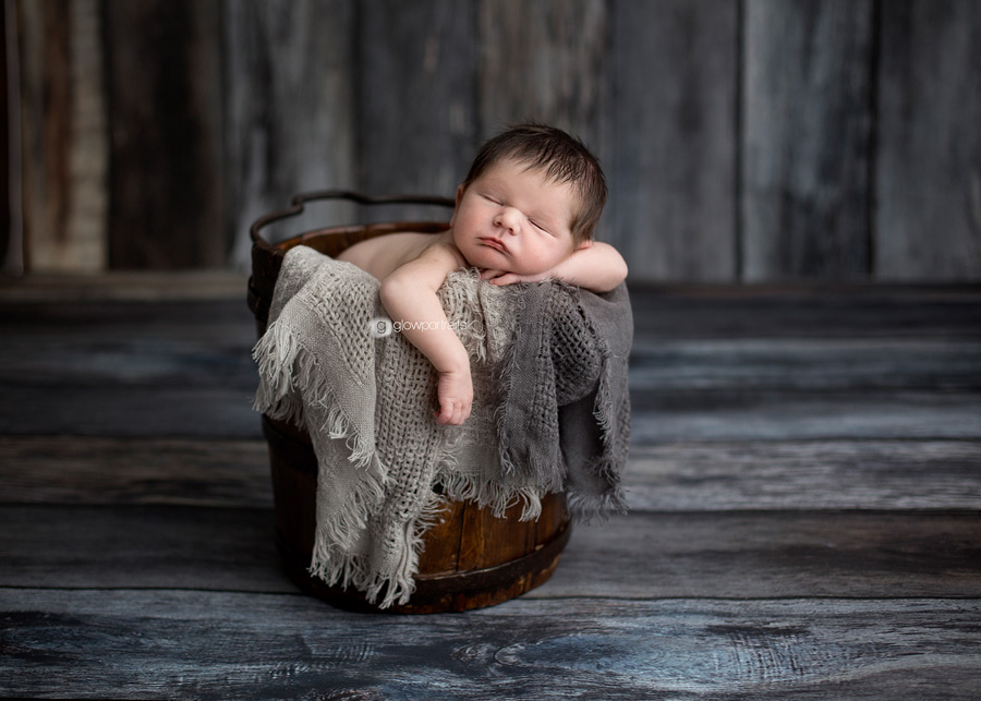 dawson creek, bc newborn photographer baby in bucket with gray blankets