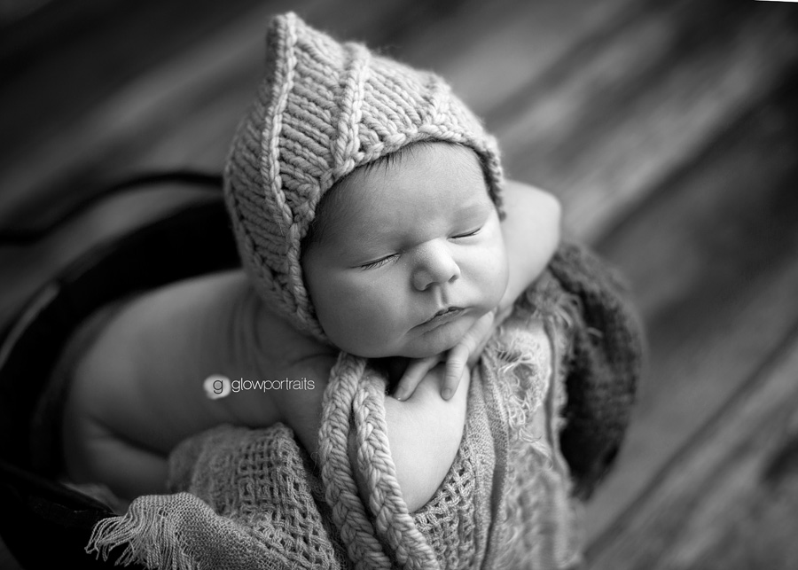 alberta newborn photographer baby with bonnet in bucket