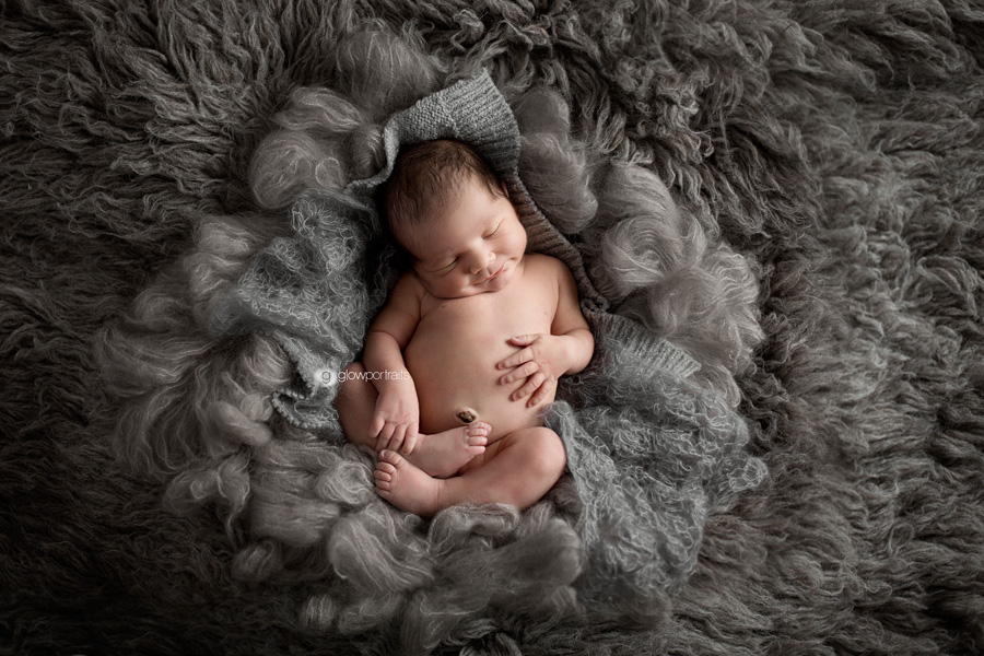 newborn smiling from above above pose