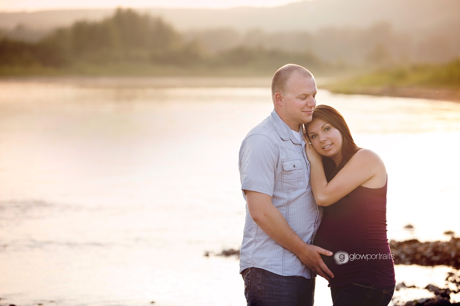 husband wife outdoors by river maternity pose