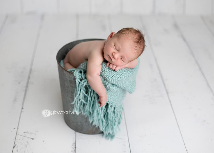 newborn boy in metal pail