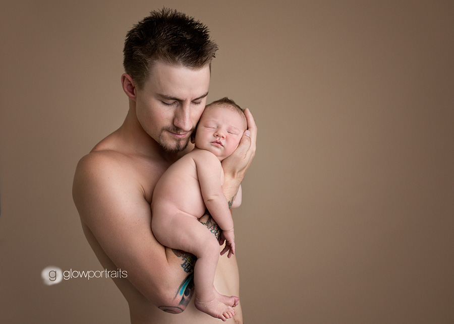 dad and newborn son pose