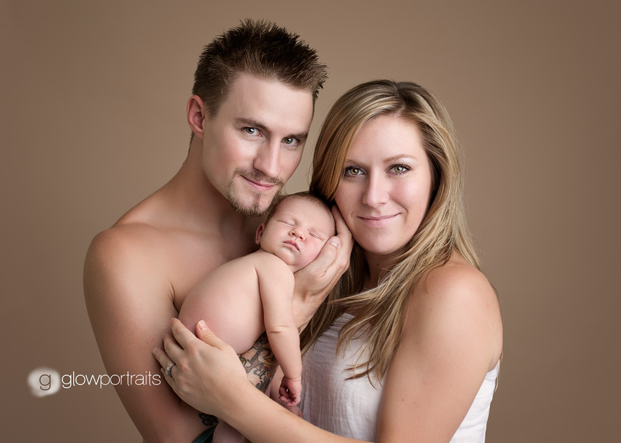 mom dad and newborn pose