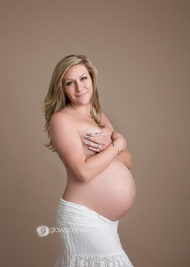 tumbler ridge photographer girl holding breasts in maternity pose