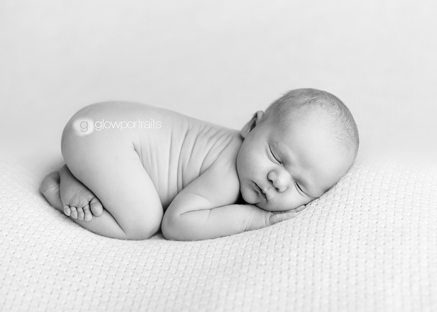 black and white image of newborn baby on beanbag