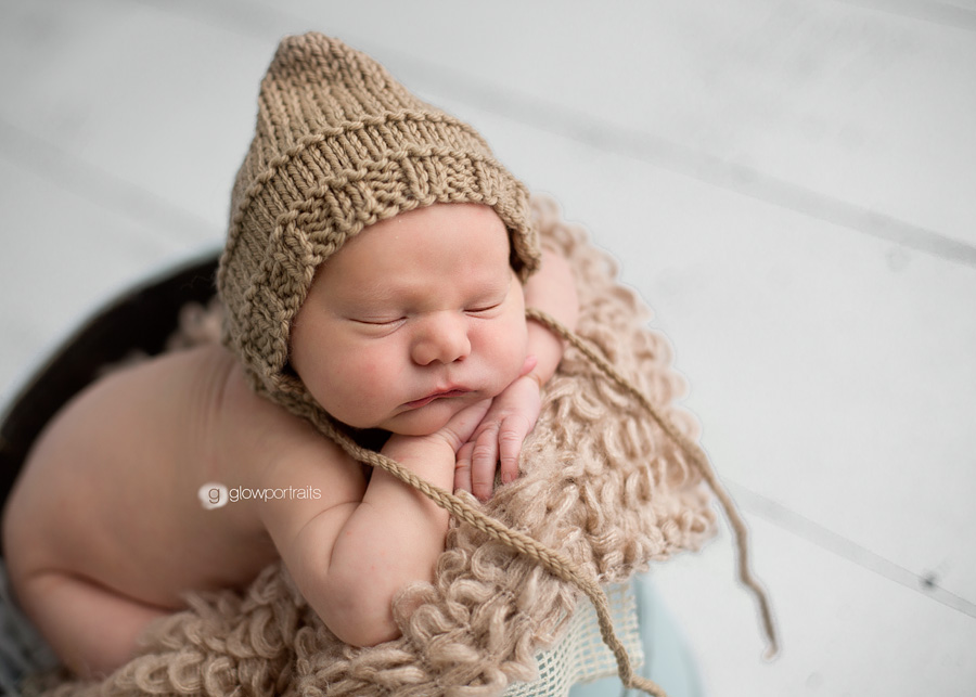 baby in bucket with hat on