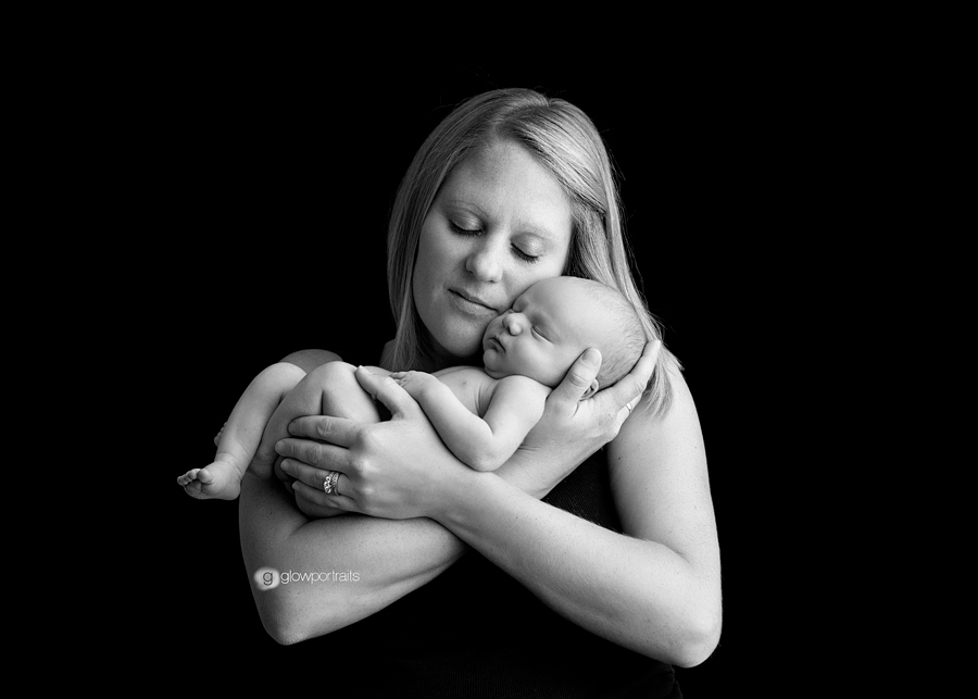glow portraits black and white image of mom snuggling newborn baby