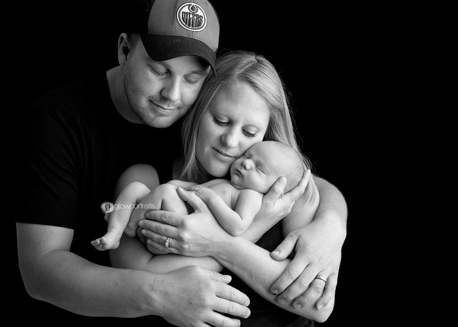 mom and dad holding newborn baby