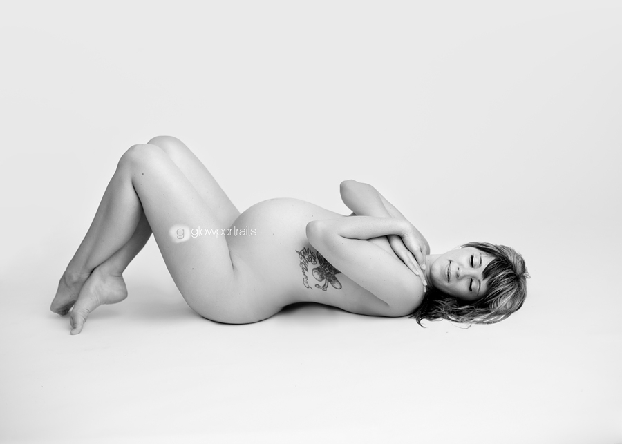 lying down naked maternity photography pose