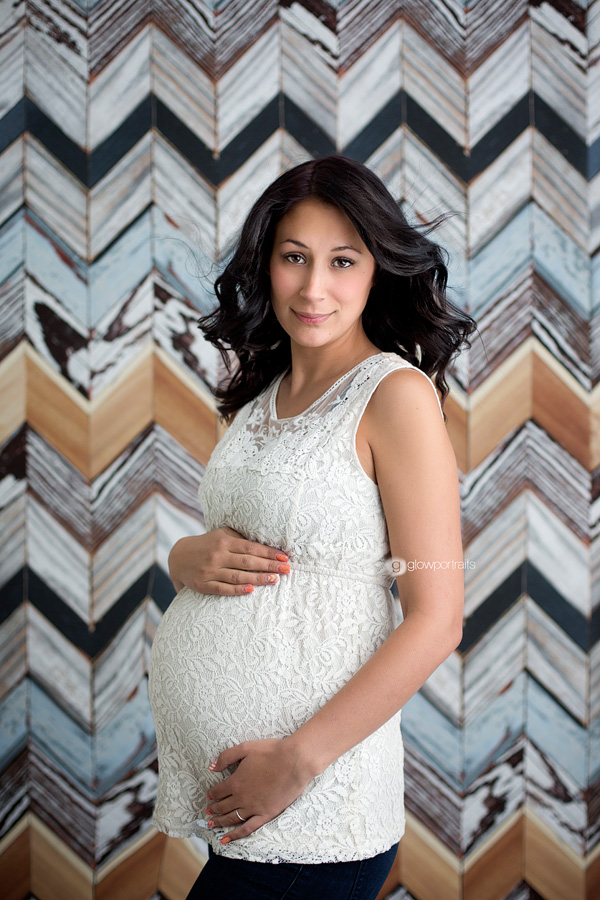 maternity portrait against chevron backrop