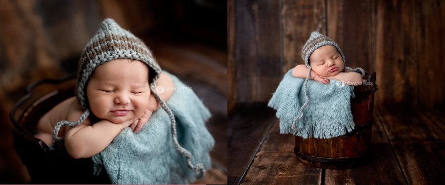 baby boy in bucket with blue bonnet