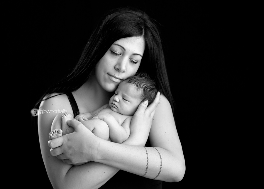 mom snuggling newborn baby boy