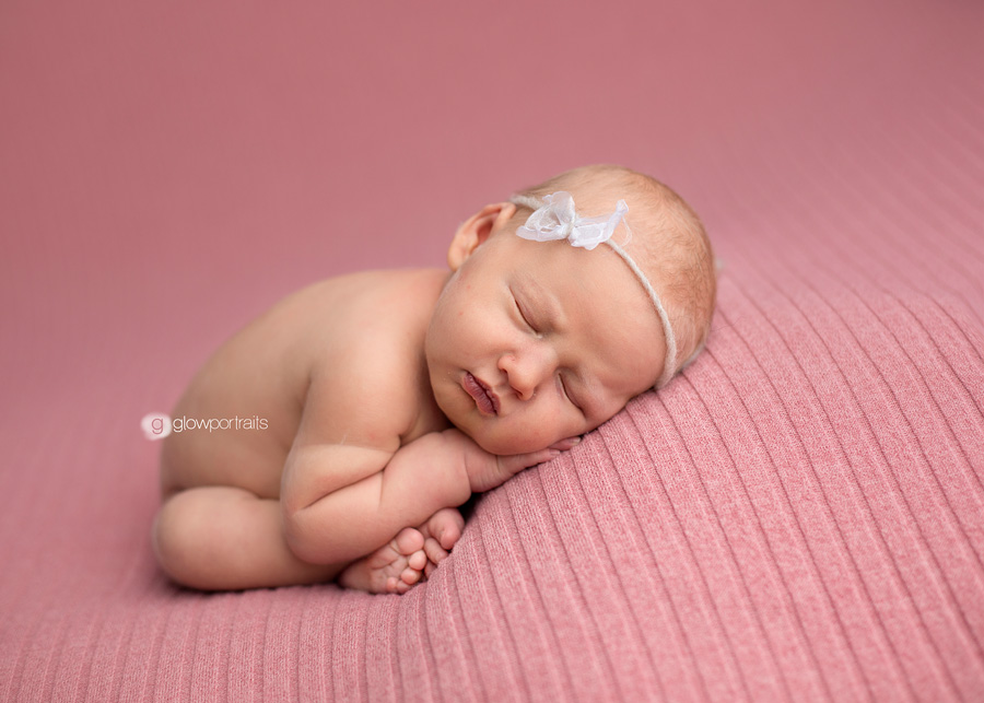 newborn in taco pose