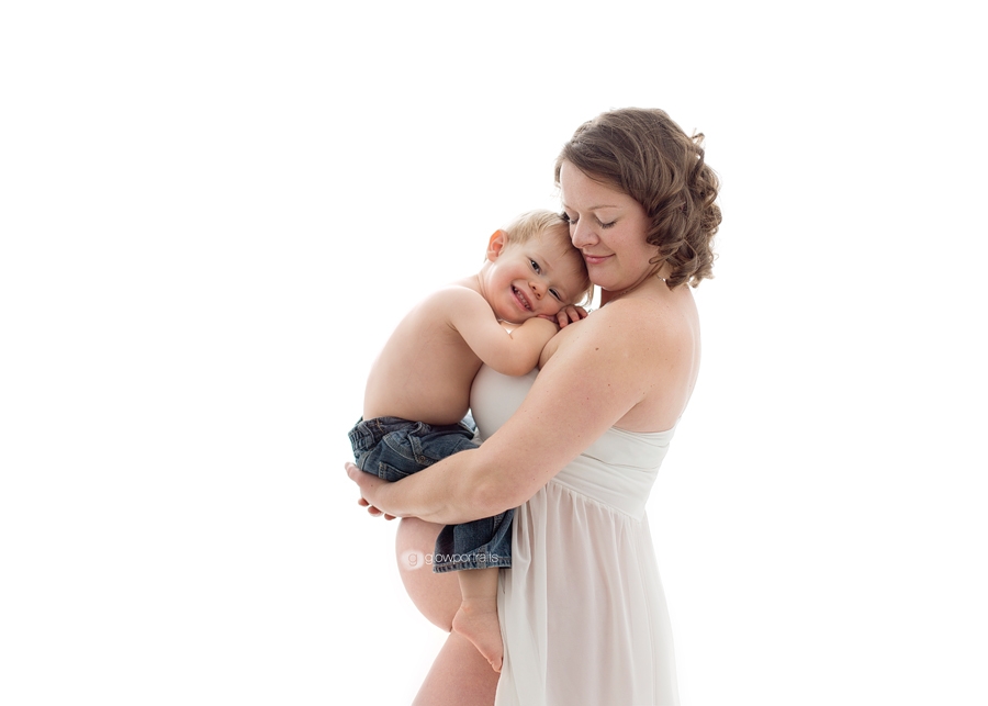 mom holding her son pregnancy pose