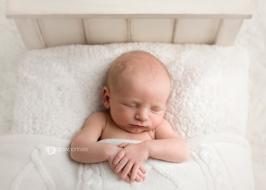 newborn in bed snuggled