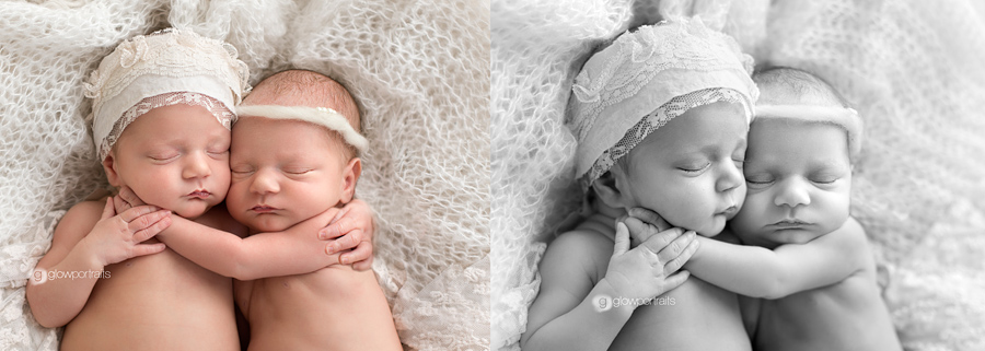 twin newborn girls holding eachother