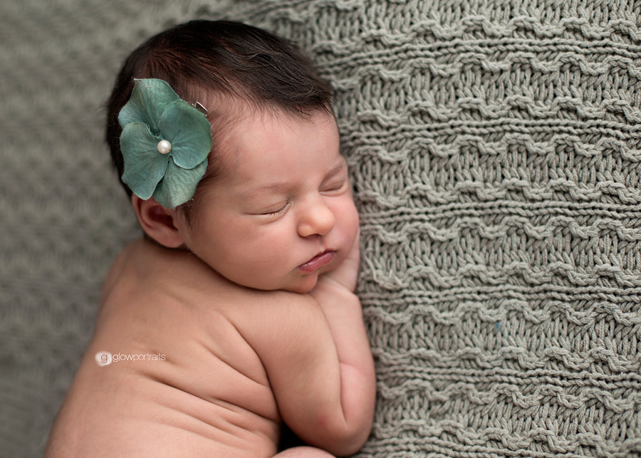 newborn girl with flower in hair