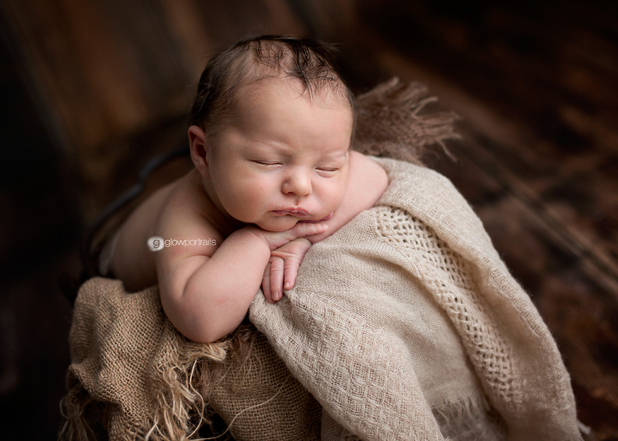newborn boy in bucket with burlap